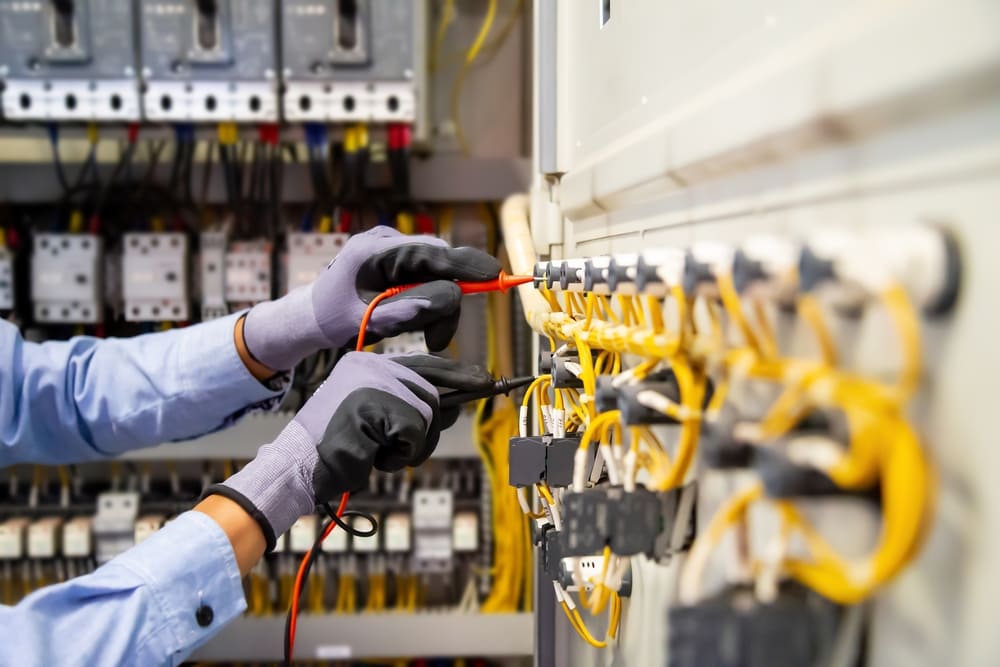 maintenance technician taking measurements