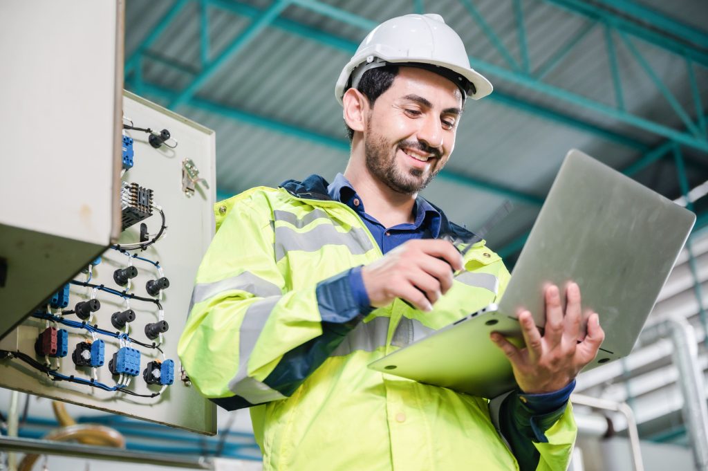 service technician organizing maintenance in his CMMS software on a laptop