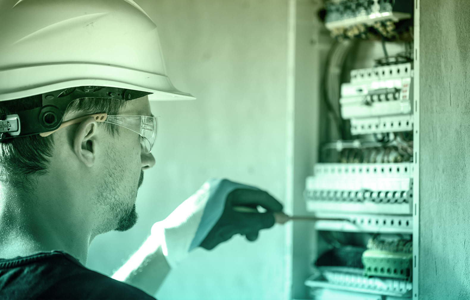 maintenance technician adjusting a switch panel