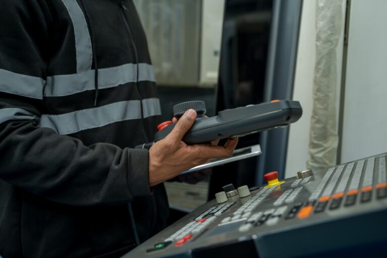 Maintenance technician taking monitoring measurements to later log in their CMMS computerized maintenance and monitoring system