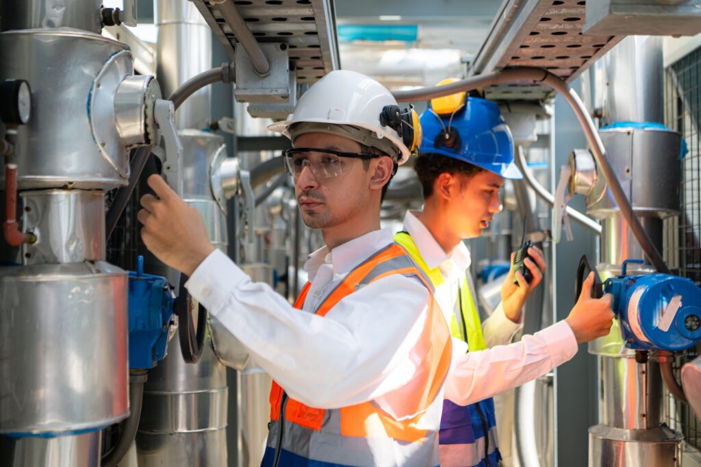Maintenance technicians opening valves and making observations to log into their CMMS