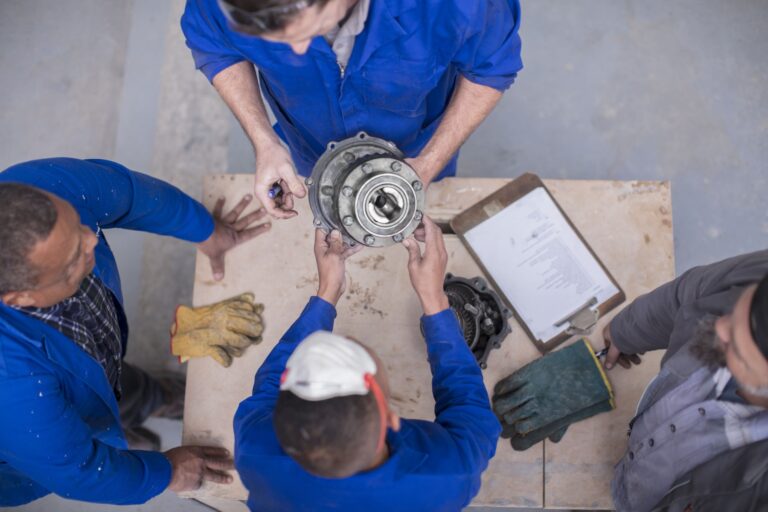 maintenance technicians maintaining and examining a gear